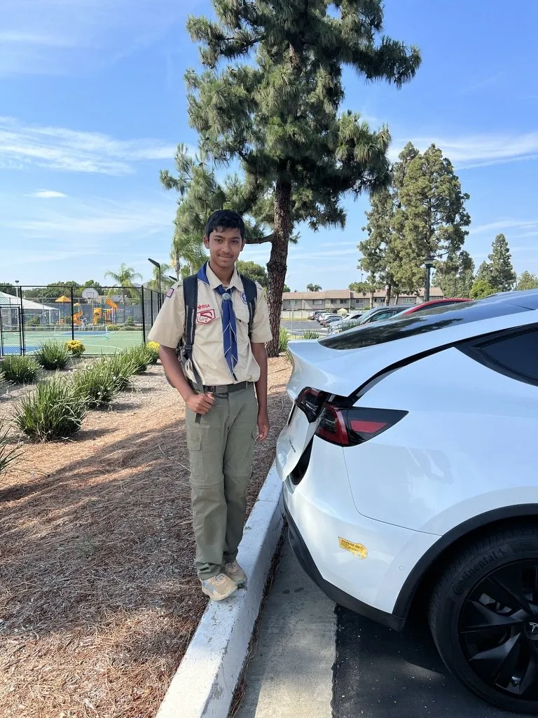 A younger Aditya in scout uniform with a backpack
